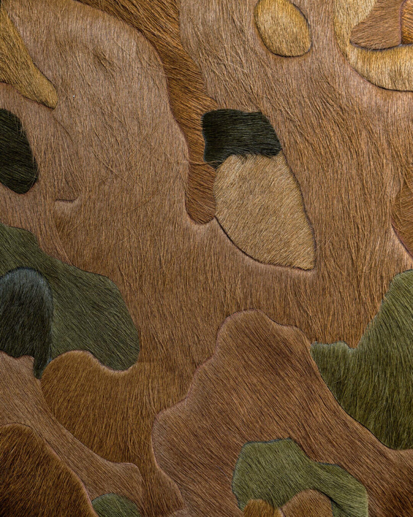 Close-up of a high end designer rug with camouflage animal fur pattern and visible hair textures.