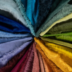 Fan-shaped luxury designer rug with hair-on-hide, blending cool to warm tones for a vibrant, high-end accent.