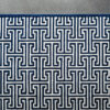 Luxury designer rug in rectangular shape, navy and white Greek key on gray background.