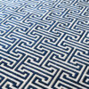 Close-up of Ripcord 03227 luxury designer rug with blue and white Greek key geometric pattern.