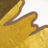 Close-up of Custom 10696 luxury designer rug in textured yellow and brown with jagged, leaf-like edges on a white background.