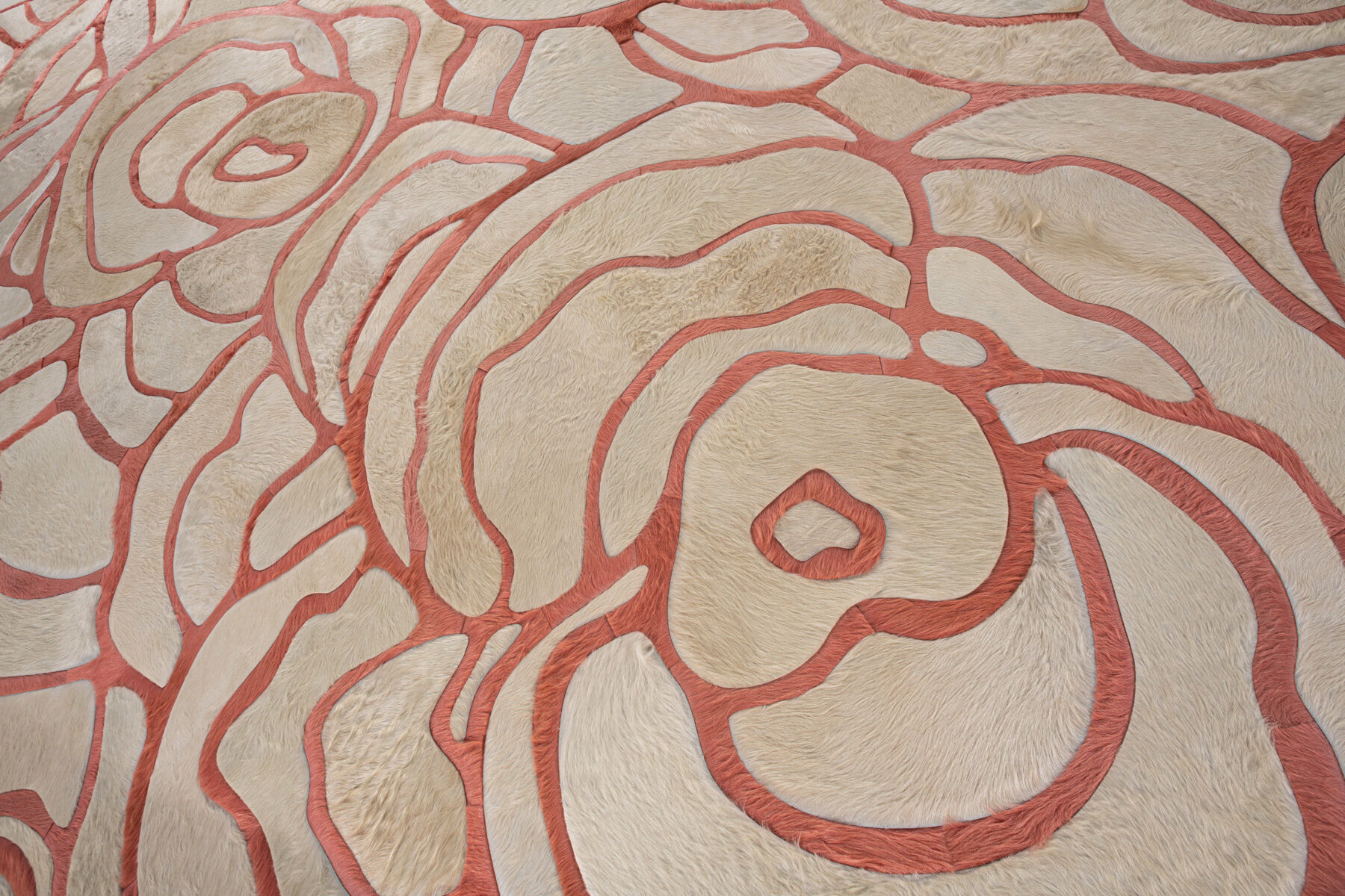 Close-up of Bloom 13575 luxury designer rug, showing high-end textured wool with abstract cream and pink patterns.