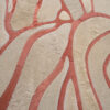 Close-up of luxury designer rug Bloom 13575 with beige and pink-red organic patterns.