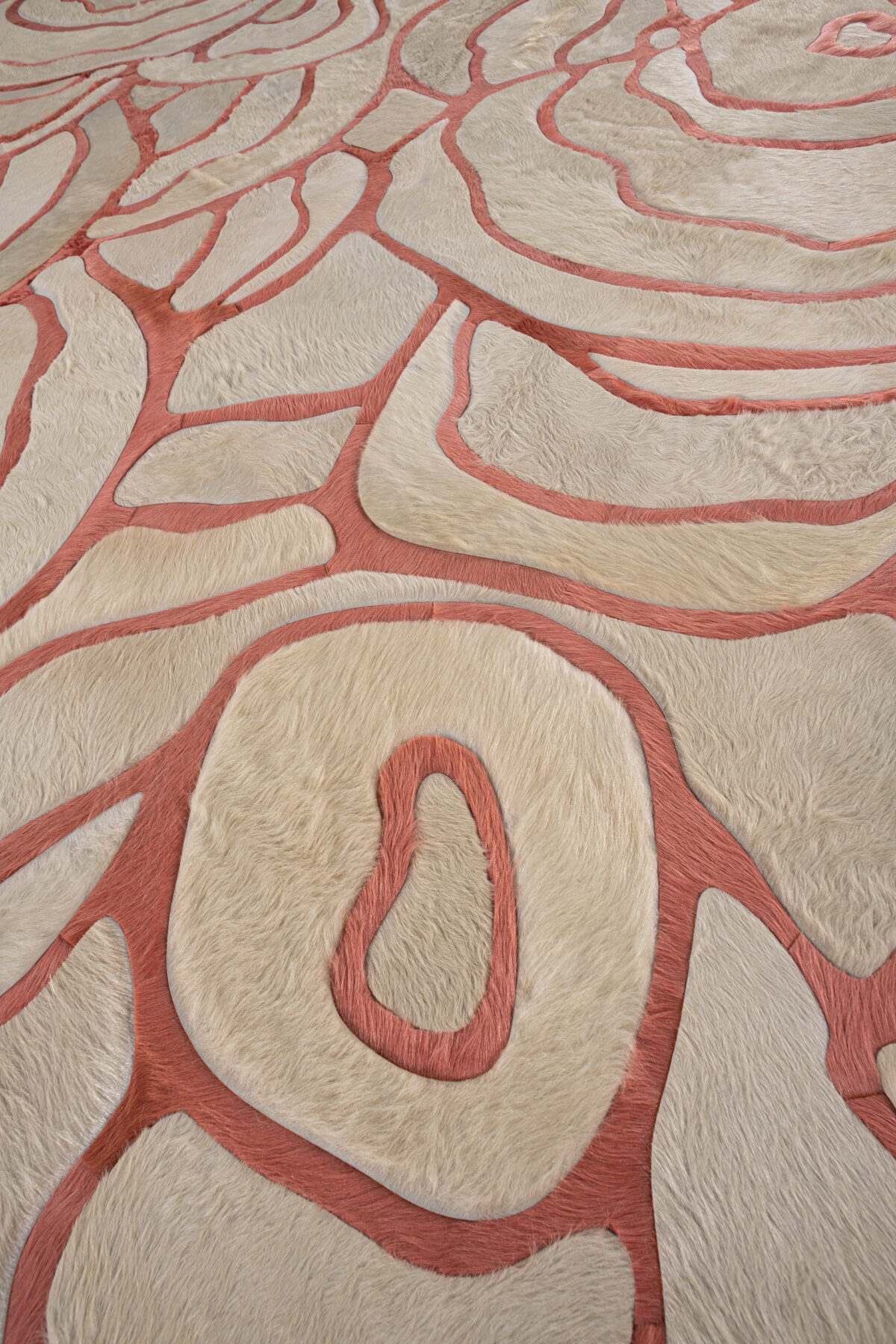 Close-up of a luxury designer rug with cream and pink abstract pattern, handmade wool, Bloom 03697.