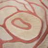 Close-up of Bloom 13575, a luxury designer rug with textured cream and pink swirls.
