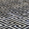 Close-up of a black and white Greek key motif on a high end designer wool rug.