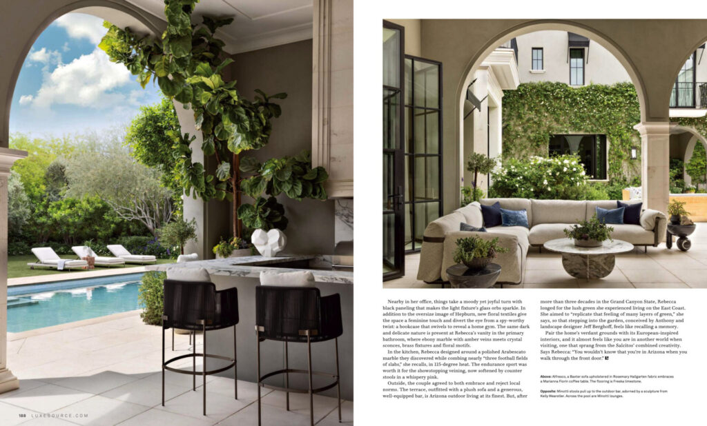 A modern patio with bar stools and luxury designer rugs overlooks a pool and garden.