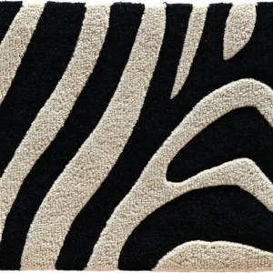 Close-up of black and cream zebra stripes on a luxury designer handmade wool rug.