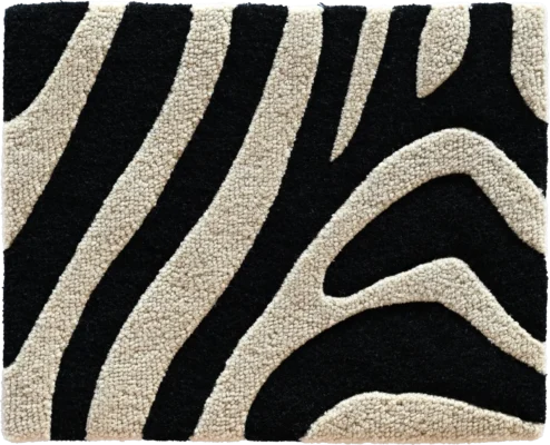 Close-up of black and cream zebra stripes on a luxury designer handmade wool rug.