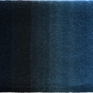 Luxury designer rug with a blue gradient, transitioning from dark to light, featuring a soft textured high-end finish.