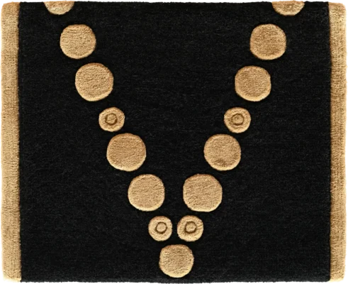 Luxury designer rug in black, with tan circles in a V pattern—high end custom mat.