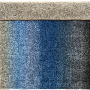 Close-up of a luxury designer rug reveals intricate handmade texture and high end quality.