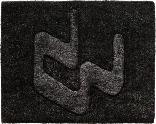 Luxury black rectangular designer rug with raised geometric center, high-end handmade wool design.