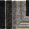 Luxury designer rug tile with geometric layered pattern in black, gray, and beige.