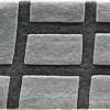 This luxury designer rug showcases a raised rectangular grid in light and dark grey tones.