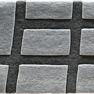 This luxury designer rug showcases a raised rectangular grid in light and dark grey tones.