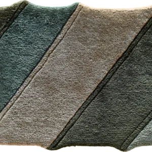 A folded towel shows designer rug-inspired diagonal blocks, ideal for luxury custom rugs décor.