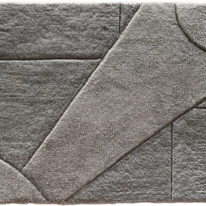 Luxury designer rectangular gray rug with raised geometric patterns and textured high end finish.