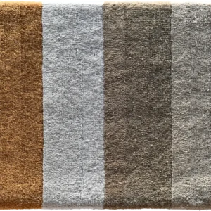 A luxury designer rug sample with four vertical stripes in brown and gray wool tones.