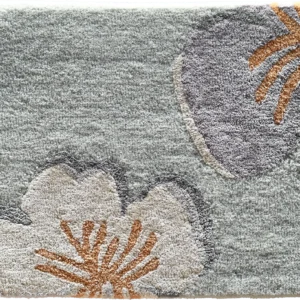 Luxury designer rug featuring a light gray base and bold beige, gray, and orange floral motifs.