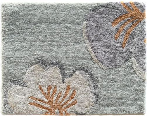 Luxury designer rug featuring a light gray base and bold beige, gray, and orange floral motifs.