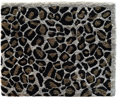 Luxury designer rug swatch with a leopard print in brown, black, and beige tones.
