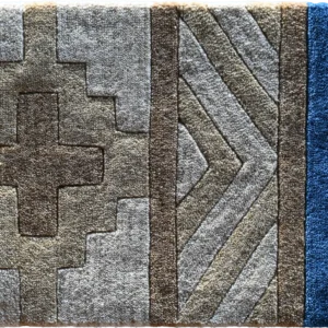 Luxury designer rug with geometric patterns in beige, brown, gray, and blue tones.