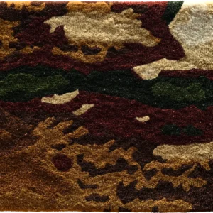 Luxury designer rug sample featuring an abstract camouflage motif in earthy tones.