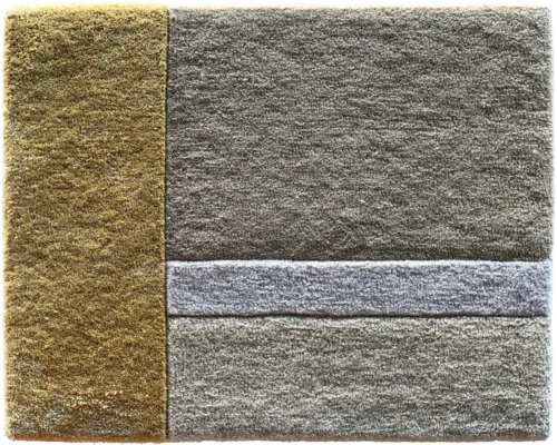 Luxury designer rug featuring a textured square pattern with gold, light, and dark gray accents.