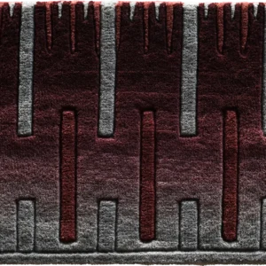 Luxury designer rug with vertical raised lines and a burgundy to gray gradient pattern.