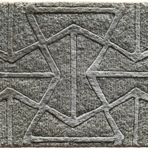 A close-up of a luxury designer gray rug features textured, geometric raised patterns in high-end, custom quality.