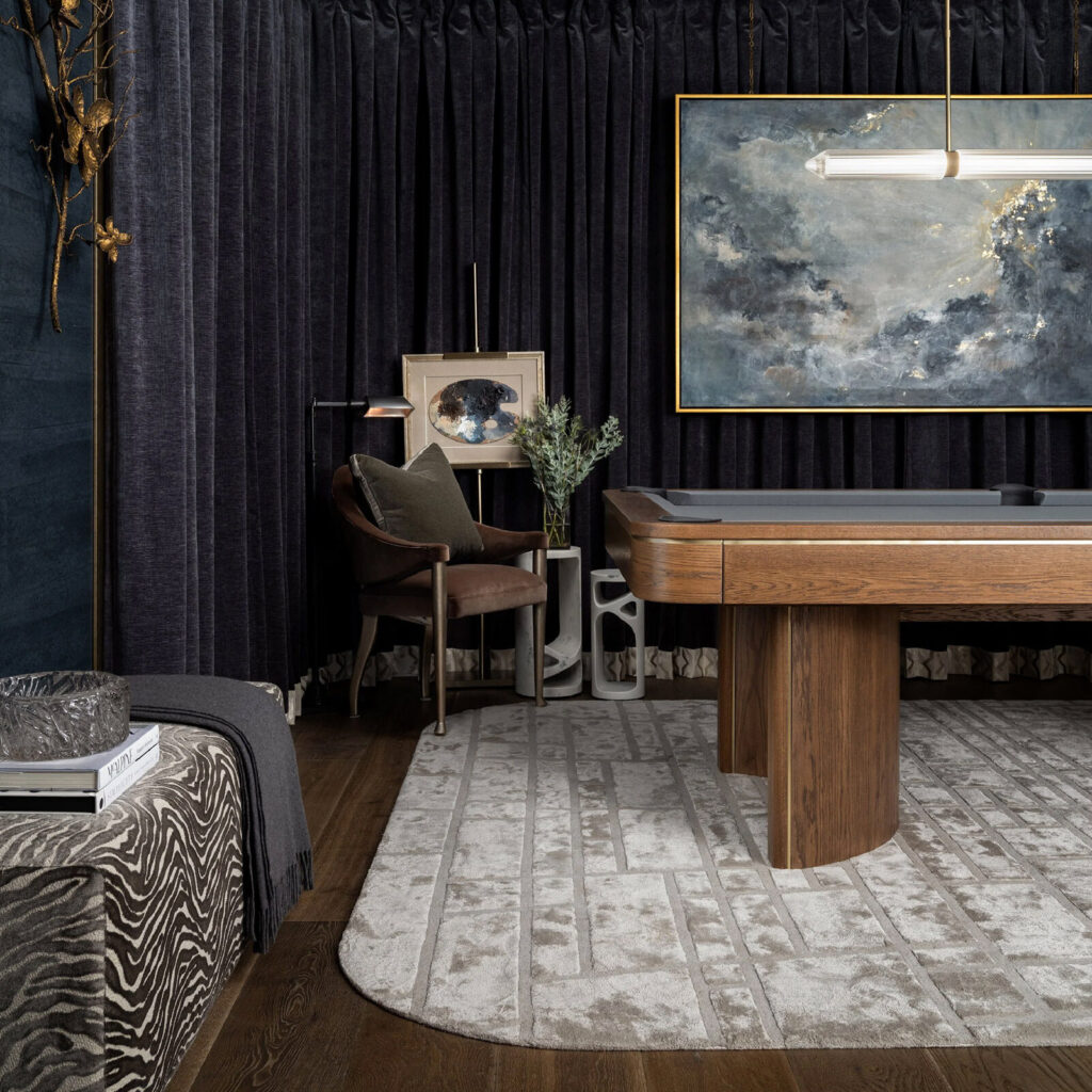 A modern room with a wooden pool table atop a luxury custom designer wool rug.