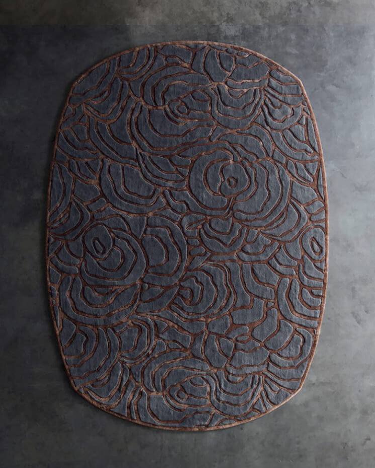 Luxury designer oval rug, abstract gray and brown pattern on stone-style floor.