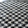 Close-up of Blackdog Hide 14697 luxury designer rug with geometric arrow pattern in black, white, and gray handmade hide.