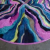 Luxury designer rug featuring circular, fur-like texture with multicolored wavy stripes.