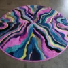Submerge Hide 14897 is a luxury designer rug with colorful wavy bands flowing onto the floor.