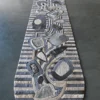Mika Hide 29748 luxury designer rug with abstract geometric stripes in grey, blue, and beige on a dark floor.
