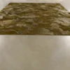 The Submerge Hide 25491 luxury handmade hide rug in earth tones on a sleek floor.