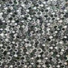 A close-up of a luxury designer rug with overlapping semicircle patterns in green, gray, white, and black.