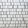 Close-up of elegant white tiles in a grid, perfect backdrop for high end designer rugs.