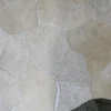 Close-up of a luxury designer rug with patchwork Custom Hide 13780 in light and dark beige.