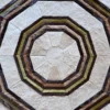 Luxury designer rug with handmade hide, concentric rings, polygons in white, brown, and tan.