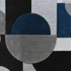 Luxury designer rug with geometric semi-circles and rectangles in gray, black, and blue on a textured wool surface.