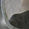 Close-up of a luxury custom designer rug, an irregular handmade hide patchwork on polished concrete.