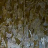 Luxury designer rug Submerge Hide 25491 with metallic waves in brown, gold, silver.