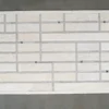 Luxury designer rug featuring rectangular white hide tiles in a brick pattern with dark gray accents.