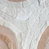 Luxury designer rug with overlapping curved beige, cream, and tan shapes, soft fur-like high-end texture.