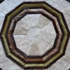Luxury designer rug with concentric octagons in brown, cream, and tan animal hide.