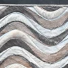 A close-up of a high end designer rug with wavy textured patterns in brown, gray, and cream luxury hide.