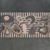 Mika Hide 29748 luxury designer rug with abstract shapes on black and tan stripes, viewed from above.